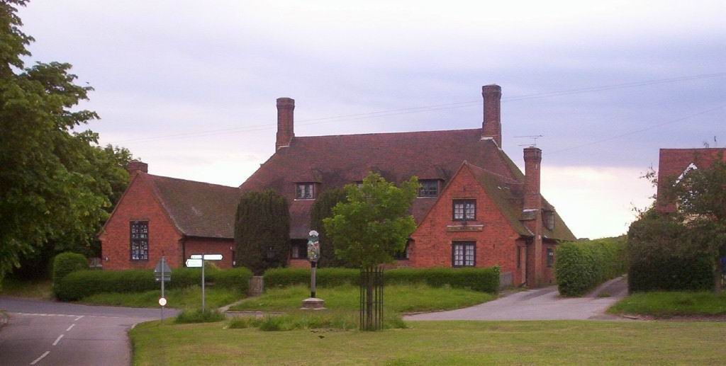 The Memorial Hall with village sign and millennium oak 